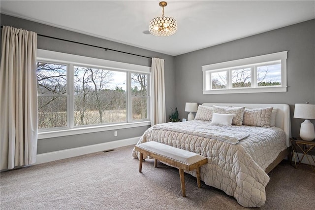 3426 Creek Ridge Dr, Eau Claire, WI 54703 - carpeted bedroom featuring visible vents, baseboards, and a notable chandelier