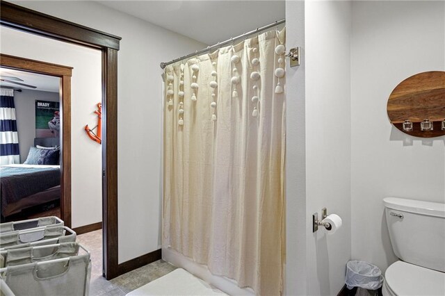 3426 Creek Ridge Dr, Eau Claire, WI 54703 - bathroom with toilet, a shower with shower curtain, ensuite bathroom, and baseboards