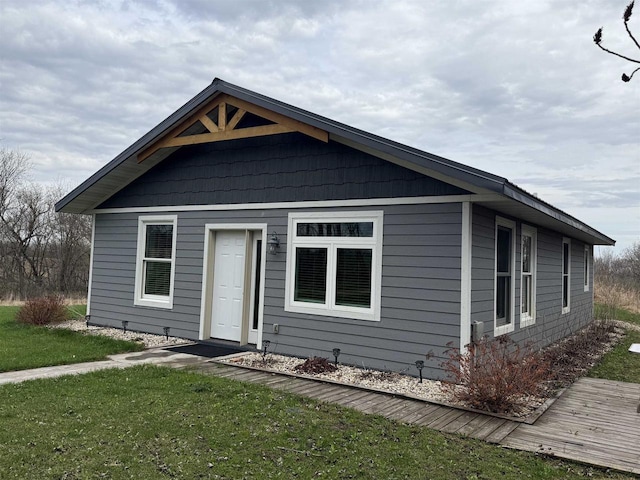 bungalow-style home featuring a front yard
