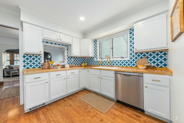 kitchen featuring stainless steel dishwasher, a sink, recessed lighting, and ornamental molding