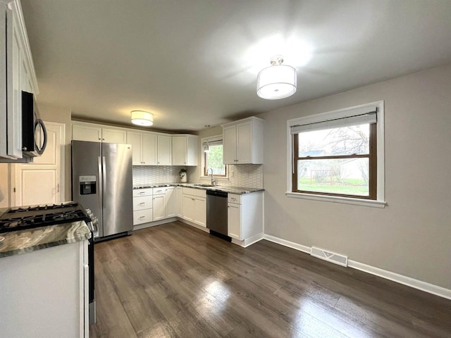 1139 Roscoe St, Green Bay, WI 54304 - kitchen featuring visible vents, appliances with stainless steel finishes, dark wood-style flooring, and a sink