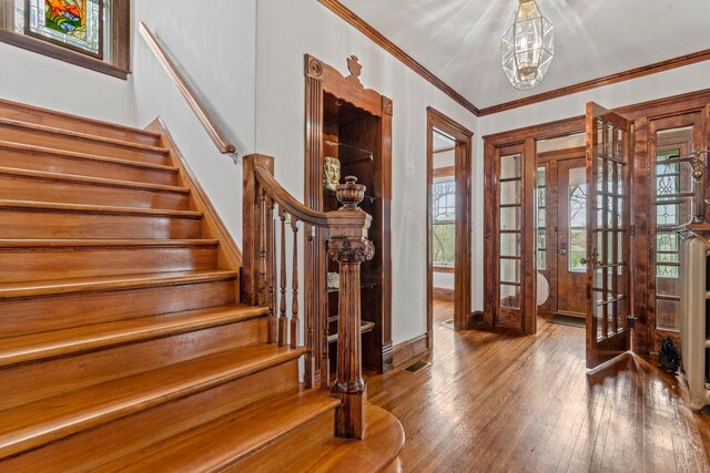 28094 E State Rd, Island Lake, IL 60042 - foyer entrance featuring stairs, hardwood / wood-style flooring, french doors, a notable chandelier, and visible vents