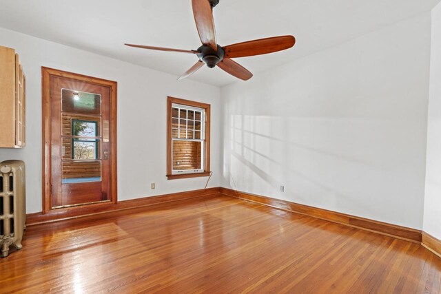 28094 E State Rd, Island Lake, IL 60042 - spare room featuring hardwood / wood-style floors, a ceiling fan, baseboards, and radiator