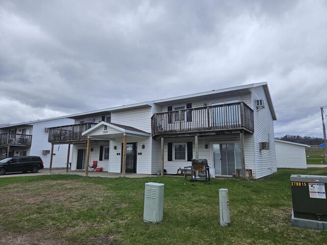 exterior space featuring a patio area, a front yard, and a deck