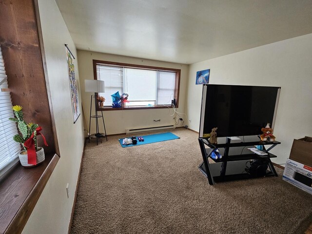 workout area featuring a baseboard heating unit and carpet flooring