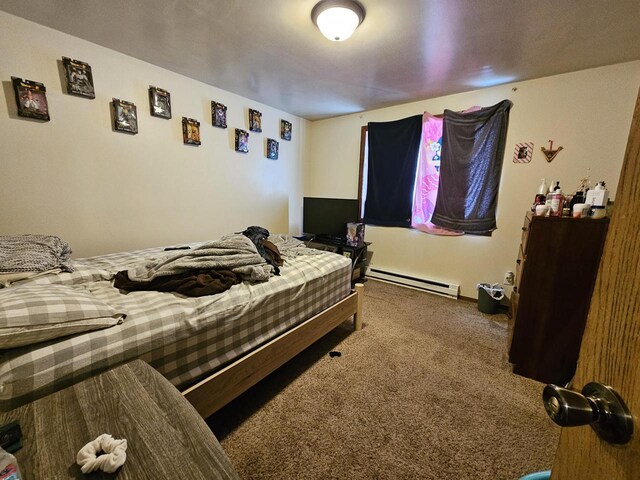 bedroom with baseboard heating and carpet flooring