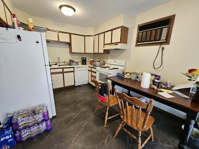 kitchen with a textured ceiling, a sink, white appliances, light countertops, and under cabinet range hood