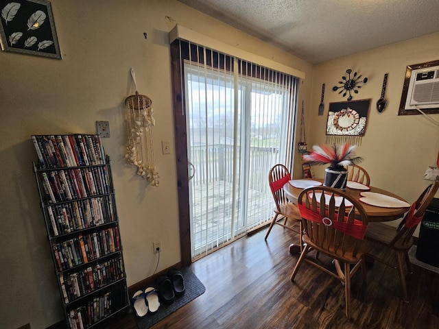 dining room with wood finished floors and a textured ceiling