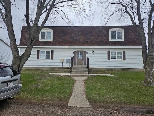 cape cod house with crawl space, a shingled roof, and a front yard