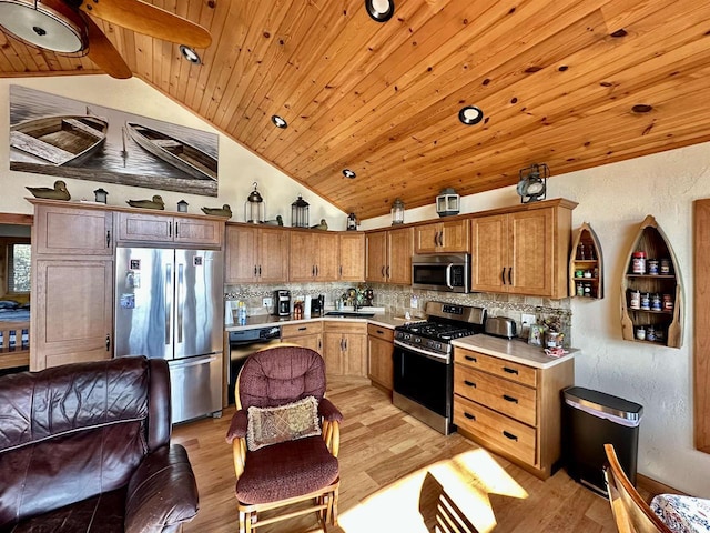 kitchen with tasteful backsplash, light wood-type flooring, vaulted ceiling, wooden ceiling, and appliances with stainless steel finishes