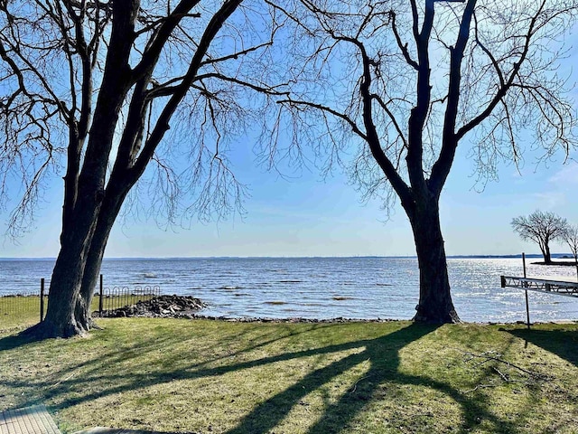 property view of water featuring fence