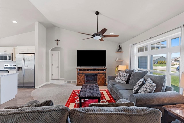 830 Roth Rd, De Pere, WI 54115 - living room with ceiling fan, arched walkways, baseboards, lofted ceiling, and visible vents