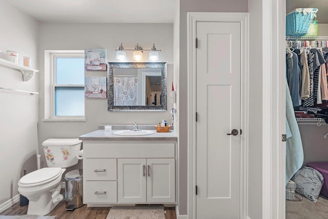 830 Roth Rd, De Pere, WI 54115 - full bathroom featuring wood finished floors, toilet, and vanity