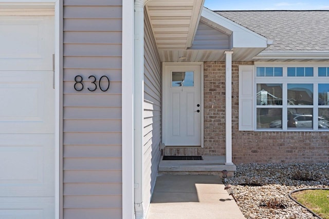 830 Roth Rd, De Pere, WI 54115 - property entrance featuring roof with shingles and brick siding