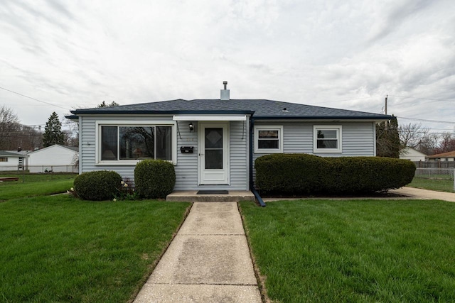 bungalow-style home featuring a front yard and fence
