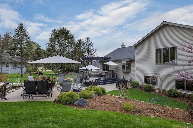 view of yard featuring a deck and a patio area