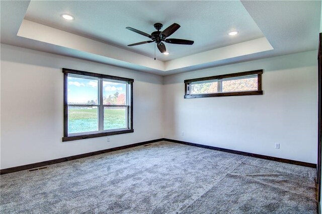 7396 124th, Chippewa Falls, WI 54729 - unfurnished room with a tray ceiling, visible vents, baseboards, carpet flooring, and ceiling fan