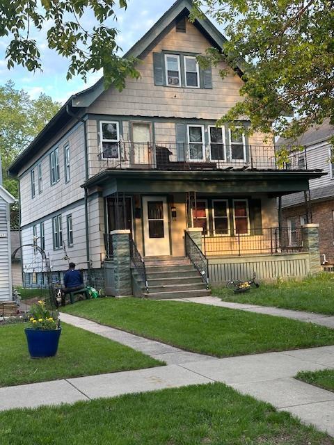 3628 N 39th St, Milwaukee, WI 53216 - view of front of home with a front yard, covered porch, and a balcony