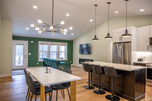 W3090 Yellow Banks Trl, Nekoosa, WI 54457 - kitchen with a center island, open floor plan, white cabinets, lofted ceiling, and appliances with stainless steel finishes