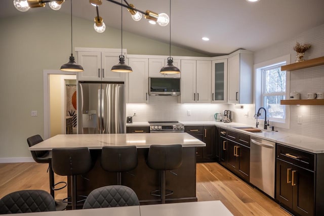 W3090 Yellow Banks Trl, Nekoosa, WI 54457 - kitchen with a sink, light wood-style flooring, lofted ceiling, appliances with stainless steel finishes, and a kitchen island