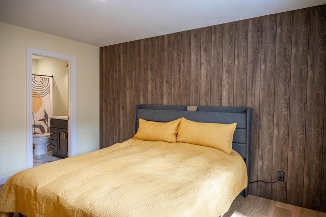 W3090 Yellow Banks Trl, Nekoosa, WI 54457 - bedroom with ensuite bath, wood finished floors, and wooden walls