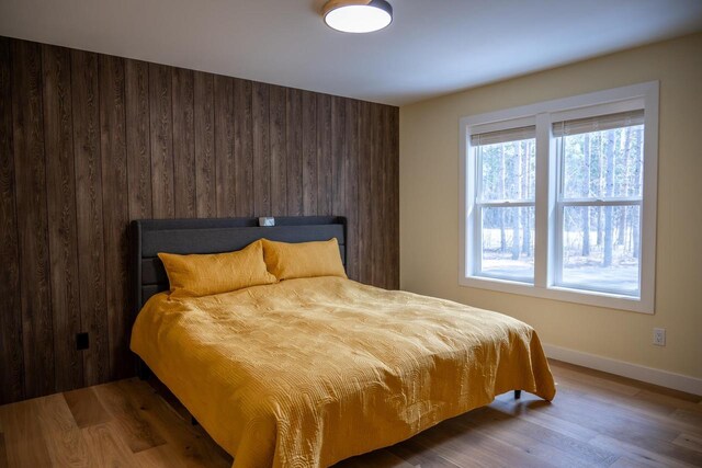 W3090 Yellow Banks Trl, Nekoosa, WI 54457 - bedroom featuring baseboards, wood finished floors, and wooden walls