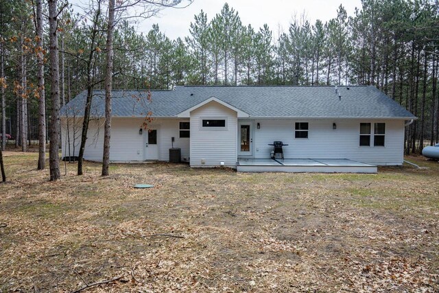 W3090 Yellow Banks Trl, Nekoosa, WI 54457 - back of property featuring a shingled roof, cooling unit, and a deck