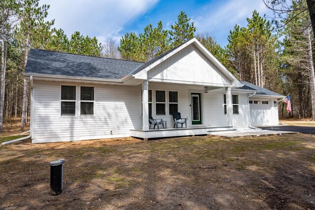W3090 Yellow Banks Trl, Nekoosa, WI 54457 - ranch-style house with a garage, a porch, and a shingled roof