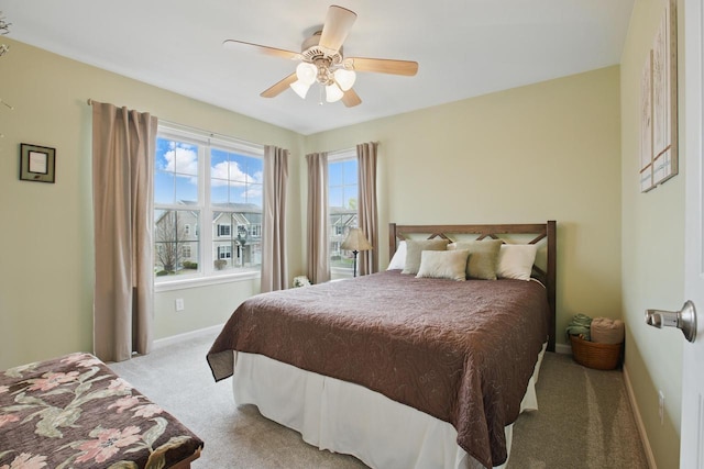 bedroom featuring carpet floors, a ceiling fan, and baseboards