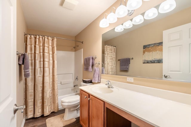 bathroom featuring visible vents, shower / bath combo, wood finished floors, vanity, and toilet