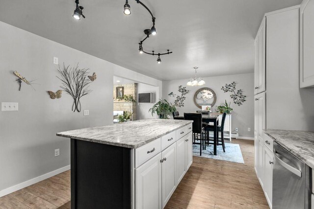 1442 Traeger St, Green Bay, WI 54304 - kitchen featuring a center island, dishwasher, a chandelier, and light wood-style flooring