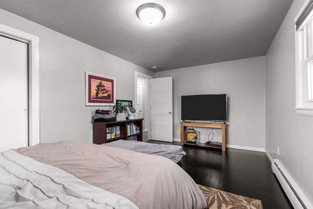 1442 Traeger St, Green Bay, WI 54304 - bedroom with a baseboard radiator, wood finished floors, and baseboards