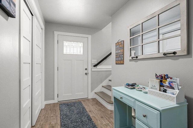 1442 Traeger St, Green Bay, WI 54304 - foyer featuring light wood-style flooring, baseboards, and stairs