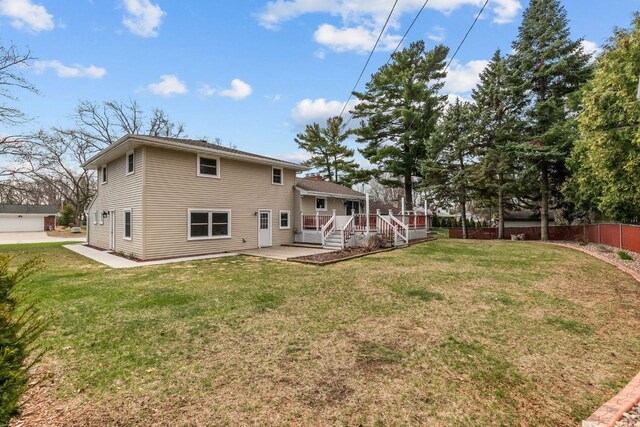 1442 Traeger St, Green Bay, WI 54304 - back of property featuring a wooden deck, a lawn, and fence