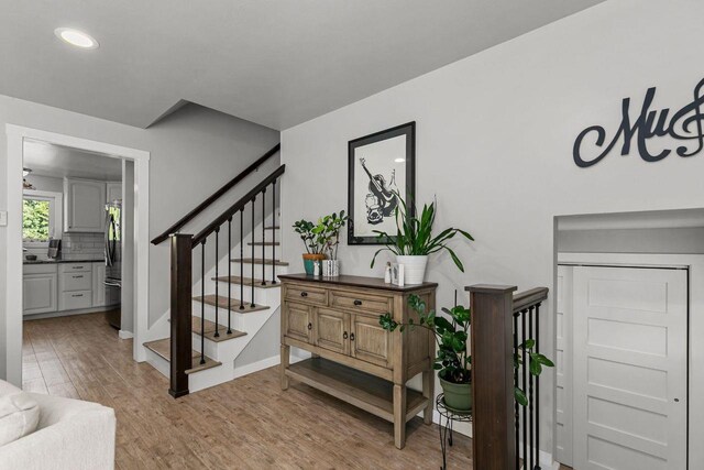 1442 Traeger St, Green Bay, WI 54304 - stairs with recessed lighting, wood finished floors, and baseboards
