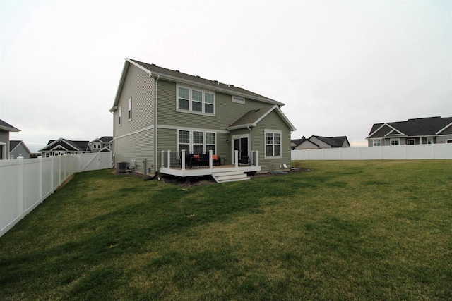 1677 Liatris Dr, Sun Prairie, WI 53590 - back of property with a fenced backyard, a wooden deck, a yard, and central air condition unit