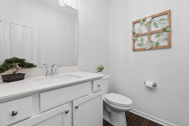 1677 Liatris Dr, Sun Prairie, WI 53590 - bathroom featuring baseboards, vanity, toilet, and wood finished floors