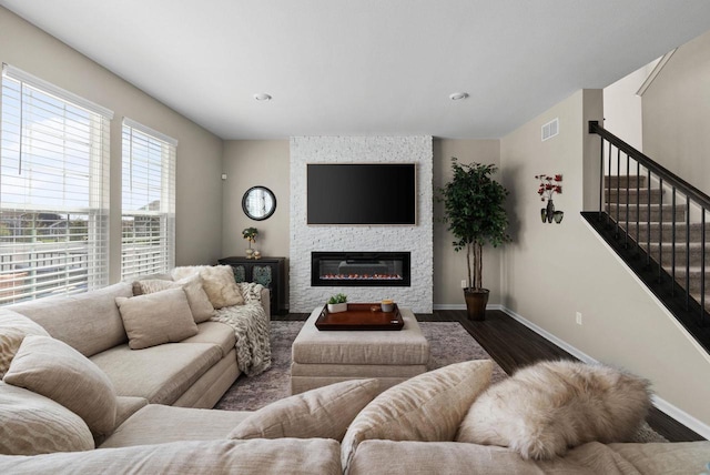 1677 Liatris Dr, Sun Prairie, WI 53590 - living area featuring baseboards, a fireplace, wood finished floors, and visible vents