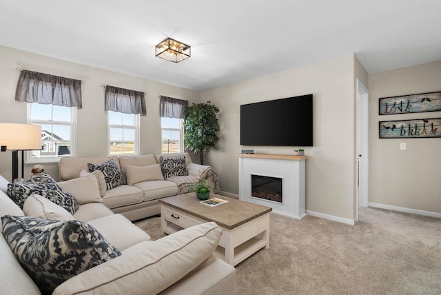 1677 Liatris Dr, Sun Prairie, WI 53590 - carpeted living area with baseboards and a glass covered fireplace