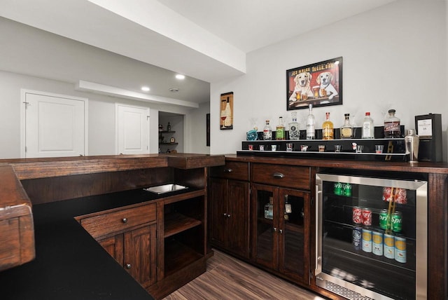 1677 Liatris Dr, Sun Prairie, WI 53590 - bar featuring beverage cooler, recessed lighting, a bar, and dark wood-type flooring