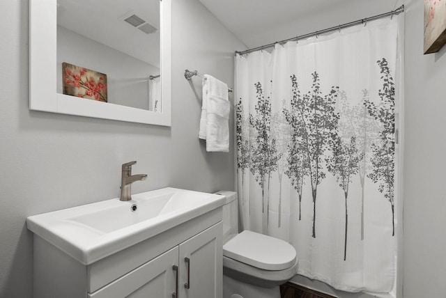 1677 Liatris Dr, Sun Prairie, WI 53590 - bathroom featuring vanity, toilet, curtained shower, and visible vents