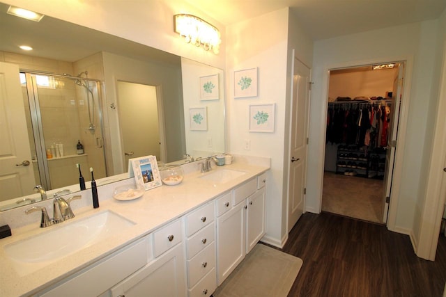 1677 Liatris Dr, Sun Prairie, WI 53590 - bathroom featuring double vanity, a sink, wood finished floors, and a shower stall