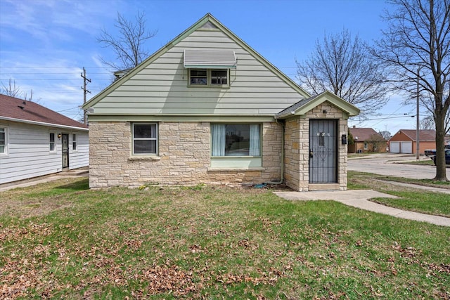 view of front of house with stone siding and a front lawn