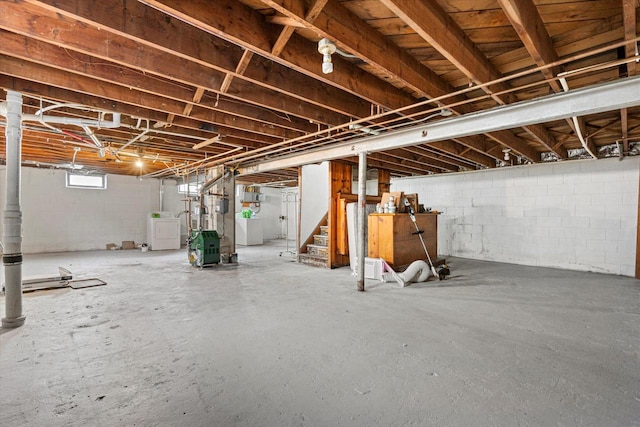 below grade area featuring stairs and washer / clothes dryer