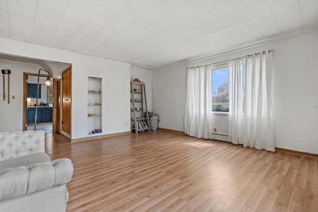 living room with built in features, light wood-style floors, and crown molding