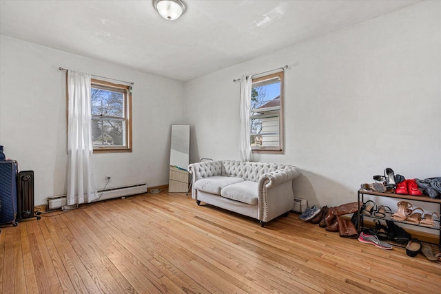 living area featuring a baseboard radiator and light wood finished floors