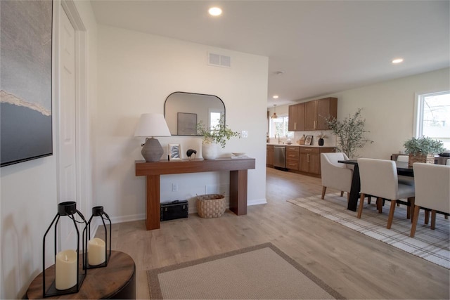 interior space with recessed lighting, visible vents, light wood finished floors, and a healthy amount of sunlight