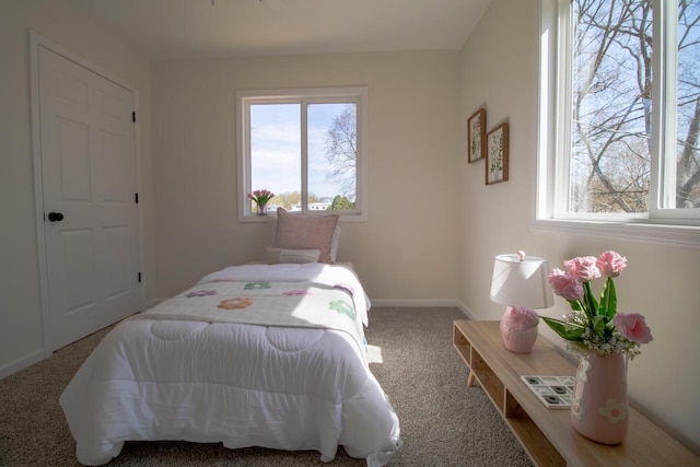 carpeted bedroom featuring baseboards