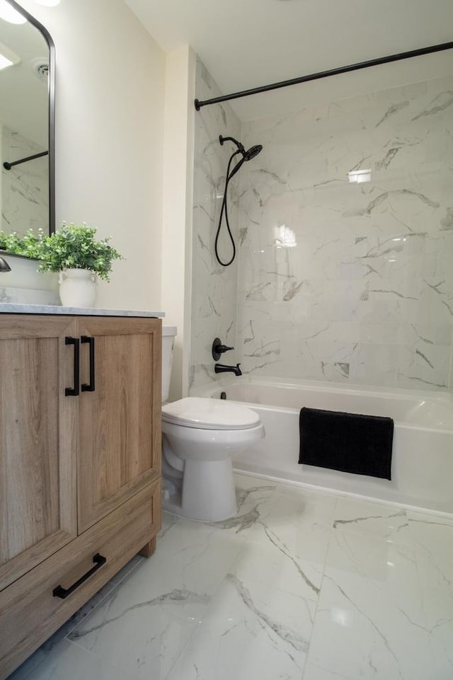 bathroom featuring bathing tub / shower combination, vanity, marble finish floor, and toilet