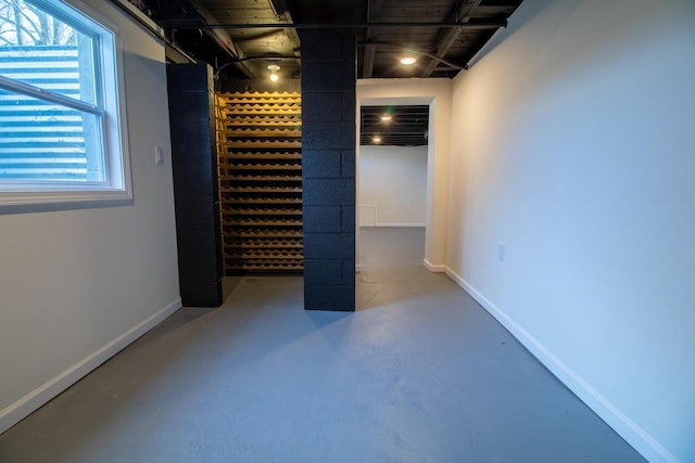 wine area with concrete floors and baseboards